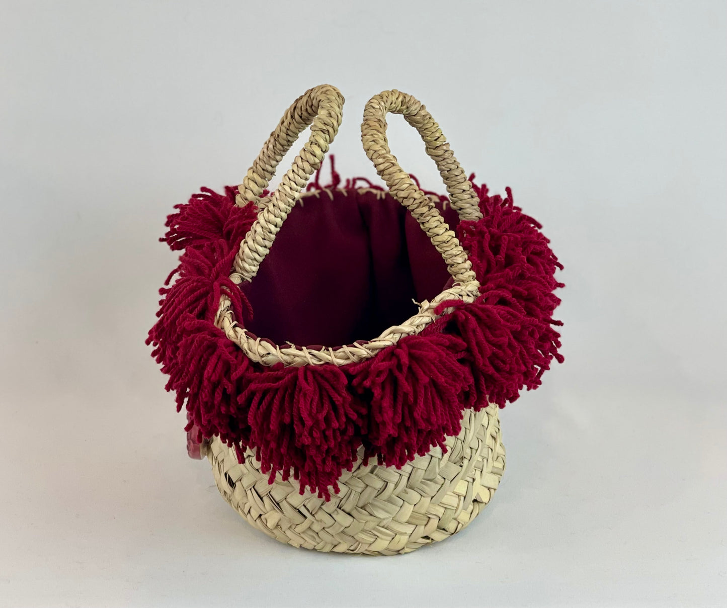 Basket with ceramic Maiden and fuchsia fringes