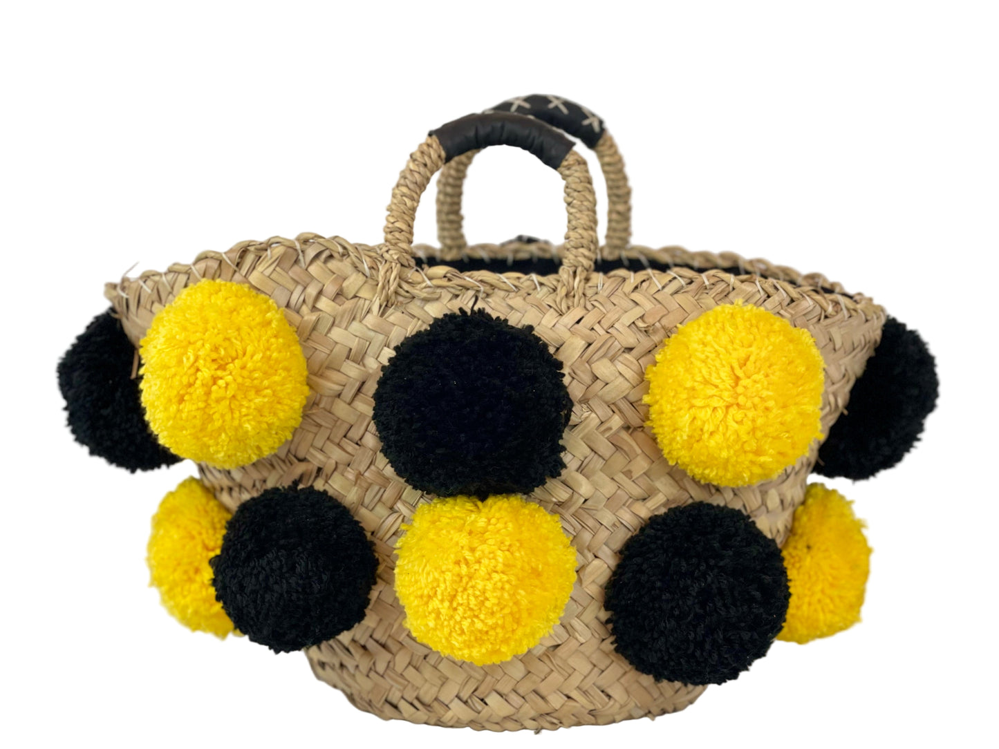 Basket with handmade yellow and black pom poms