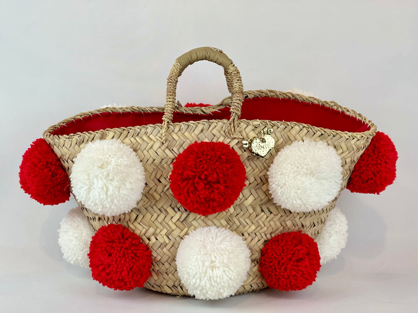 Basket with handmade white and red pom poms