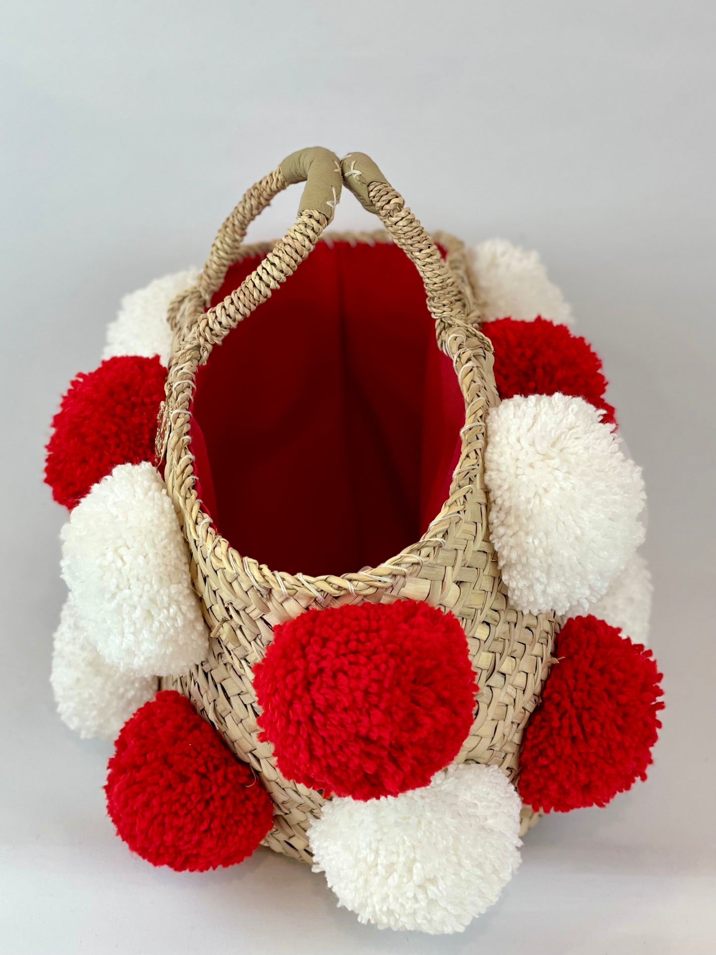 Basket with handmade white and red pom poms