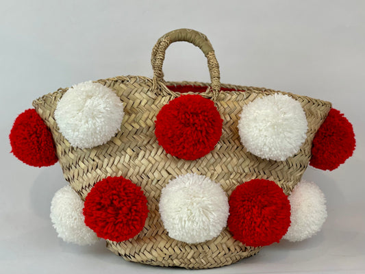 Basket with handmade white and red pom poms