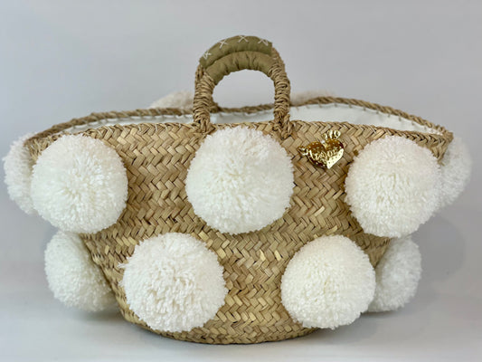 Basket with white handmade pom poms
