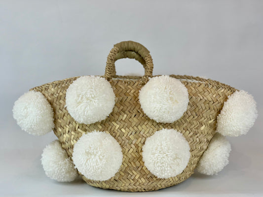 Basket with white handmade pom poms