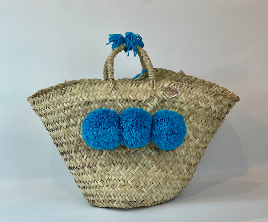 Basket with multicolored pom poms