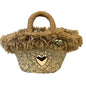 Basket with gold votive offering and beige pom poms 