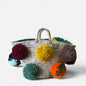 Basket with handmade white and red pom poms